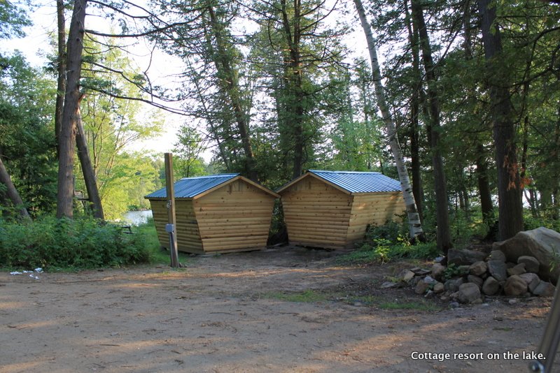 Two freshly-built cabins at the resort, roofs on, siding complete.